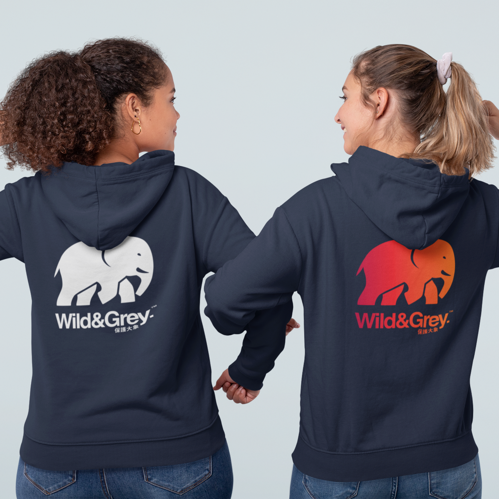 Two people wearing navy blue hoodies with 'Wild & Grey' logos on the back against a light gray background.